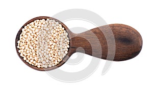 White quinoa seeds in wooden spoon, isolated on white background. Pile of raw kinwa. Top view.