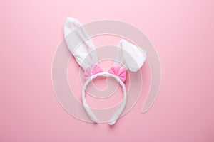 White rabbit bunny ears on pink background. Symbol Happy Easter Flat lay
