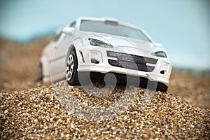 White racing toy car on rough terrain