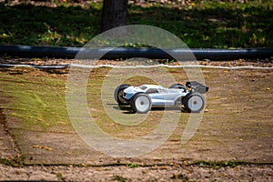 White Radio Controlled RC Offroad Truggy on an outdoor track training during sunny day