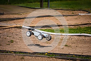 White Radio Controlled RC Offroad Truggy on an outdoor track training during sunny day