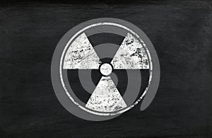 White radioactive sign over black background