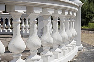 White railing in the background of columns