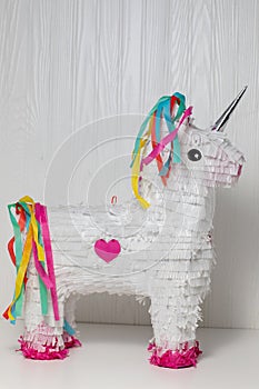 White and rainbow unicorn piÃ±ata, white background