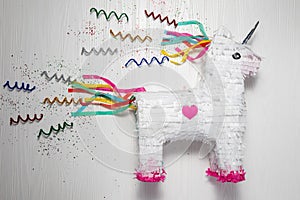 White and rainbow unicorn piÃ±ata, white background