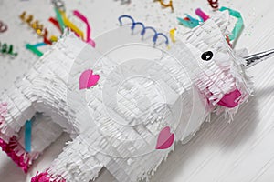 White and rainbow unicorn piÃ±ata, white background