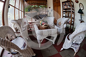 White rattan furniture on tiled floor in a hostel