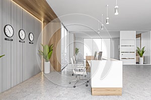 White reception room desk with amrchairs and two computers