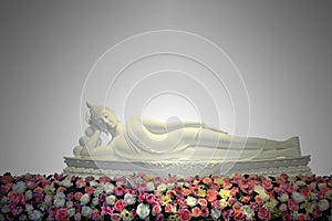 White reclining buddha statue with colorful flowers in main hall