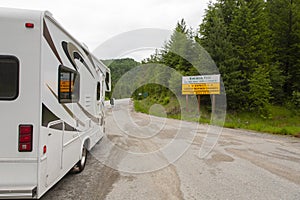 White recreational van (RV) on the road captured at Bonanza Pass in Canada