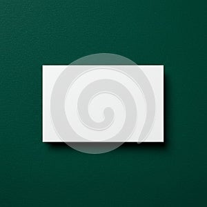 A white rectangular card is positioned on a textured dark green background. The card