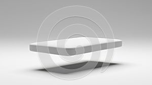 A white rectangular object is floating in mid-air against a gray background.