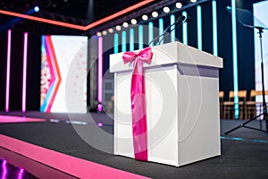 White rectangular podium with satin ribbon on neon background