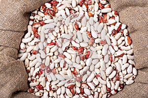 White and red beans in linen bag