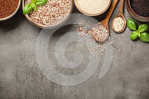 White, red, black and mixed quinoa on stone background
