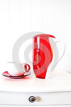 White and red ceramic flagon on white background