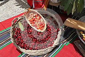 White and red cherries in wicker basket, cherry festival