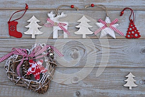White red christmas decoration as christmas tree, reindeer and star on a old grey wooden planks background with empty copy space