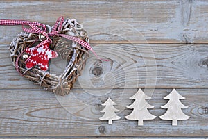 White red christmas decoration as christmas tree, reindeer and star on a old grey wooden planks background with empty copy space