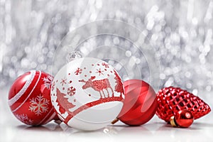 White and Red Christmas ornaments on glitter bokeh background with space for text. Xmas and Happy New Year