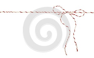 White and red Christmas wrapping rope tied in a bow isolated on white