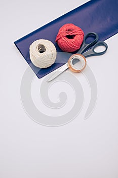 white and red decorative yarn balls on blue paper with stationery