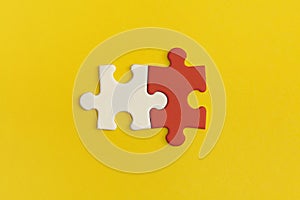 White and red details of puzzle on yellow background