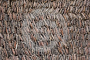 A White red gray stone tile lay in a pile. smooth rows of bricks tiles. rough surface texture