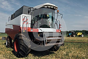 White red harvester on a sunny day in a field