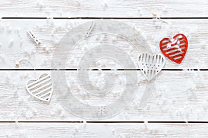 White red hearts and snowflakes on wooden table, romantic love card, Valentines day background, top view, copy space
