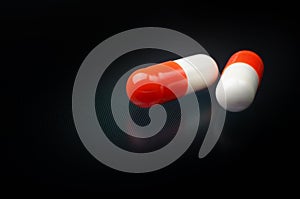 White and red medicine antibiotic pills