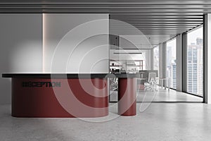 White and red office reception area with maroon reception counter and blank wall