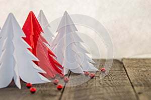 White and red origami Christmas tree with red decoration