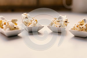 White spoon with popcorn. photo