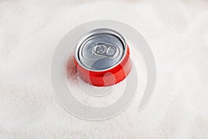 White refined sugar and Red can with sweet carbonated drink. Top view, copy space. Concept - Excess Sugar in Soda