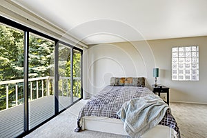 White refreshing bedroom interior with walkout deck photo