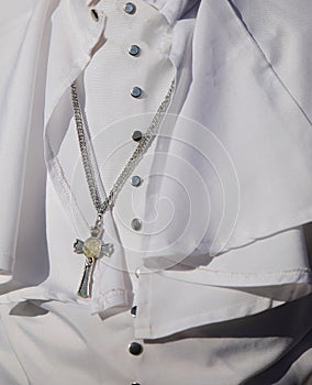 White religious cassock worn by the pontiff during ceremonies with the crucifix photo