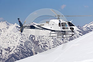 White rescue helicopter in the mountains