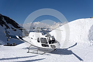 White rescue helicopter parked in the mountains photo