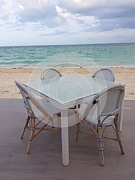 White restaurant bar table and chairs near the beach in Bahamas