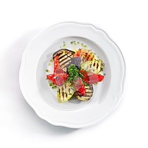 White Restaurant Plate of Grilled Vegetables and Fresh Greens Isolated