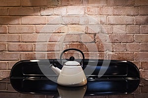 White retro tea pot on modern induction stove