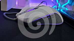 White RGB gaming mouse with gray cable in use