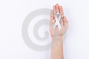 White ribbon over palm. White background