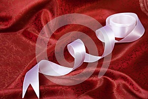 White ribbon on red drape