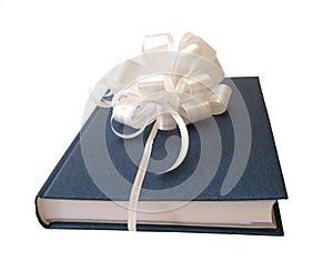 White ribbon tied blue book