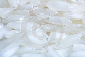 White rice grains closeup, background and texture