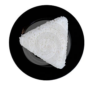 White rice triangle shape in black ceremic dish isolated on whit photo