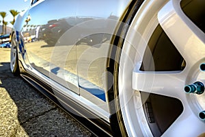 White rims with blue trimming of a close up on a car and wheels