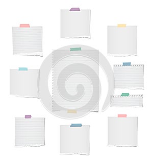 White ripped lined and blank note, notebook paper strips, sheet for text or message stuck with colorful sticky tape on